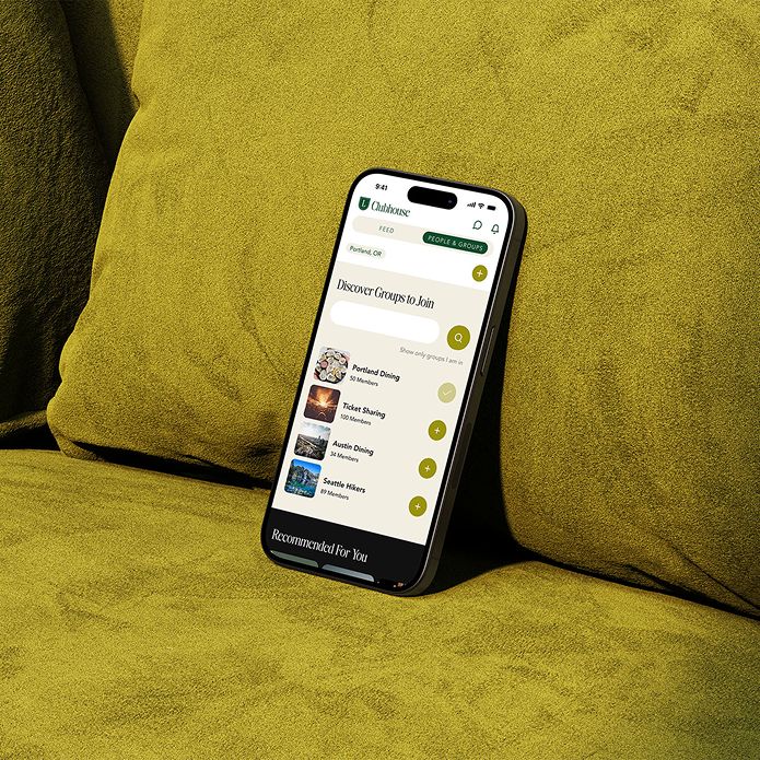 smartphone on a green couch displaying the Lesbian Culture Club App
